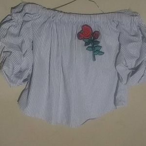 A black and white stripped off the shoulder shirt